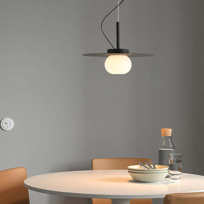 Minimalist pendant light over a dining table setting