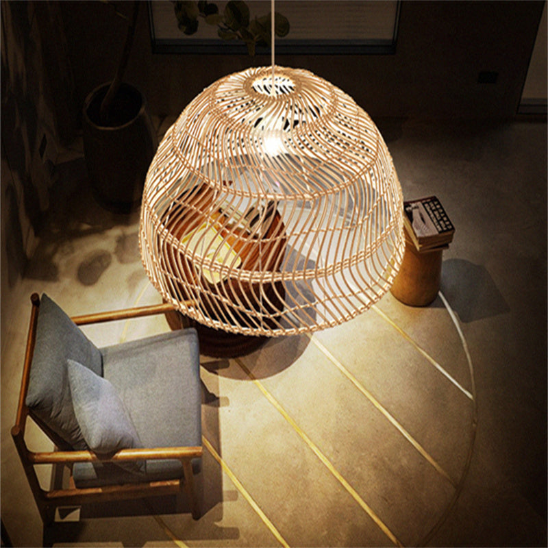 Ritta Retro Handmade Rattan Pendant Light illuminating a bedroom setting