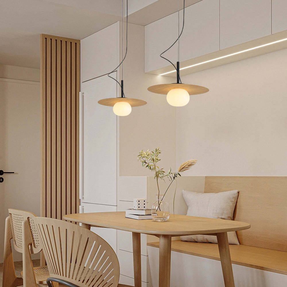 Minimalist pendant lights over a dining room setting