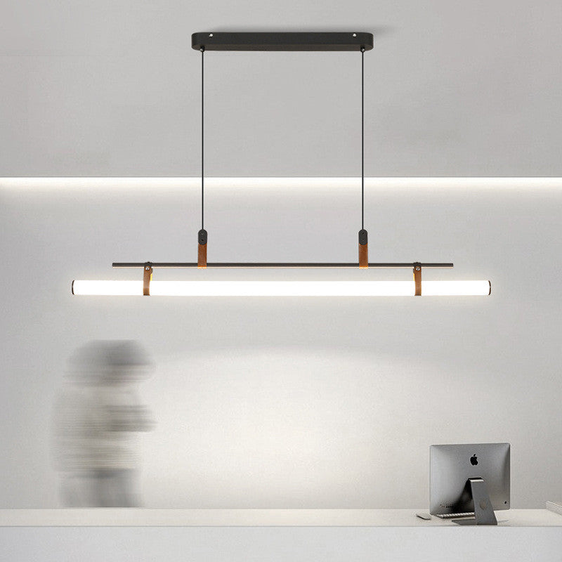 Modern linear pendant light above desk by Las Sola