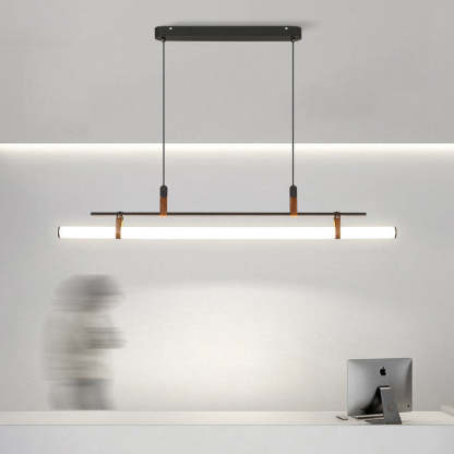 Modern linear pendant light above desk by Las Sola