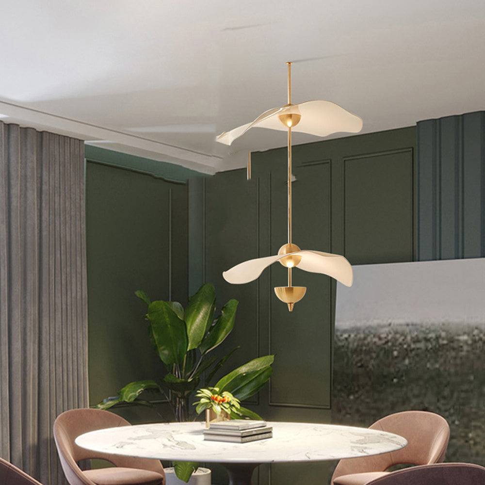 Modern gold pendant light above dining table
