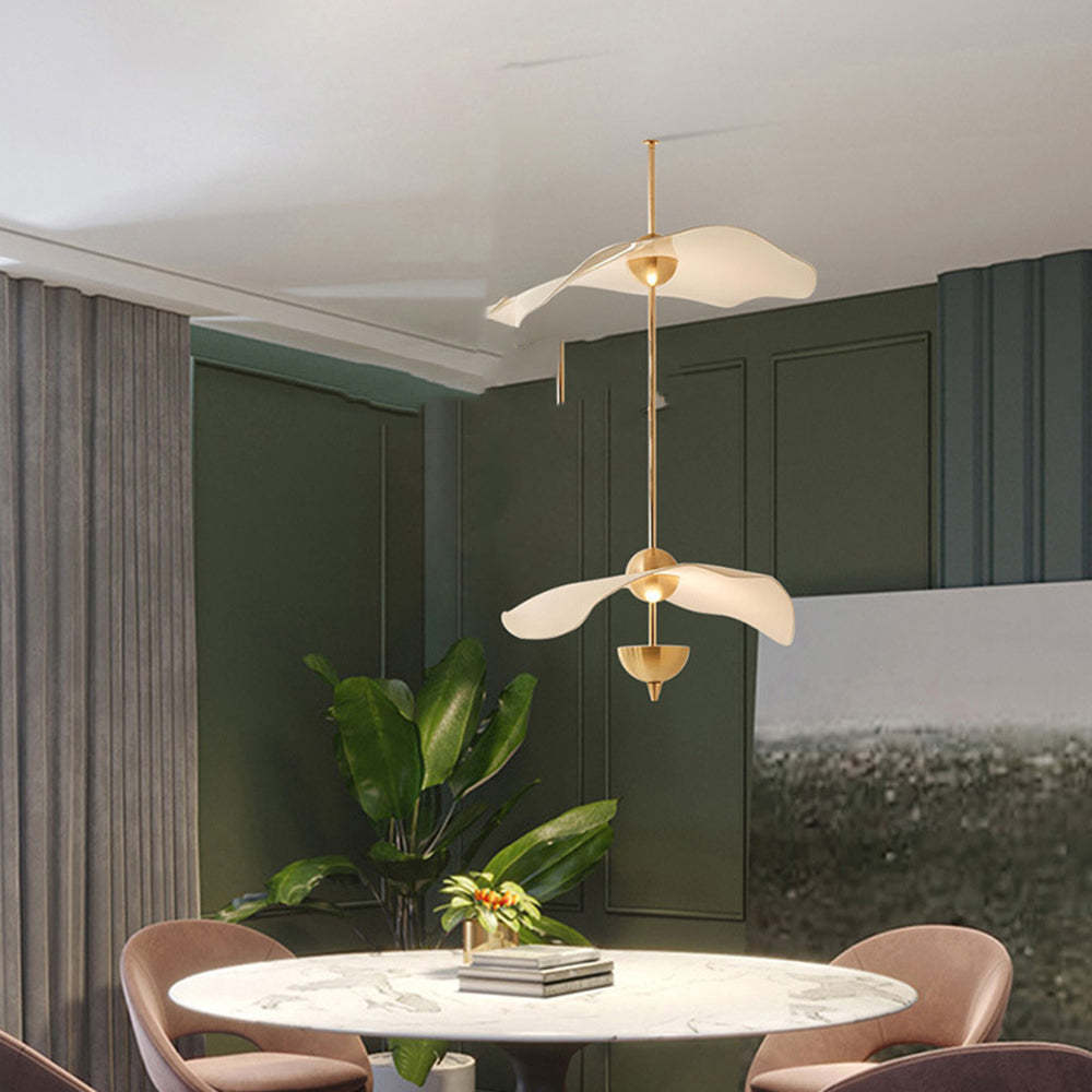 Modern gold pendant light above dining table