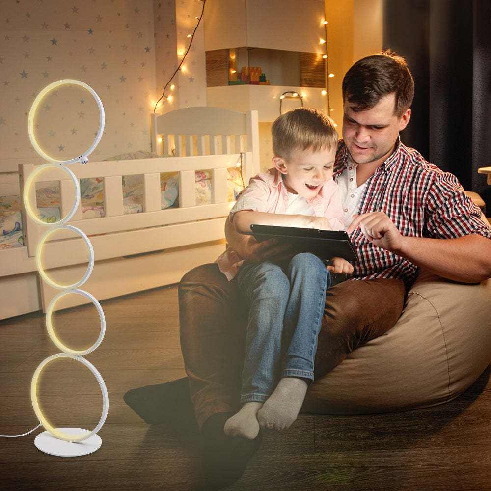 Arisha multi-ring floor lamp with family in child's bedroom.