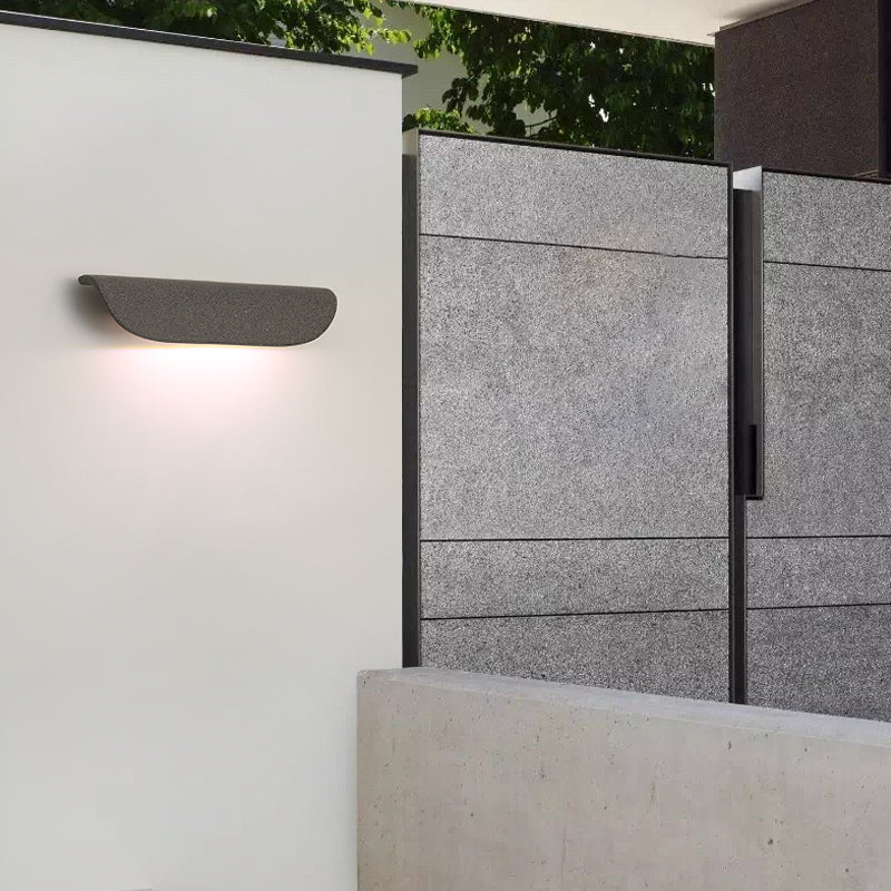 Outdoor wall lamp lighting a modern garden corridor