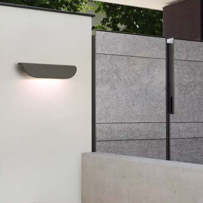 Outdoor wall lamp lighting a modern garden corridor
