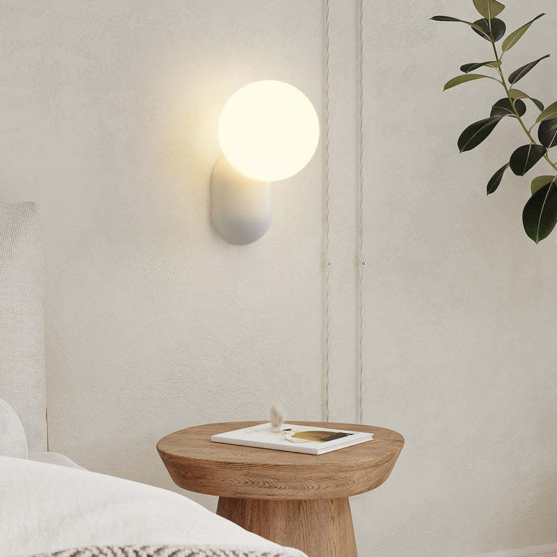 Hailie wall lamp illuminating a modern bedroom