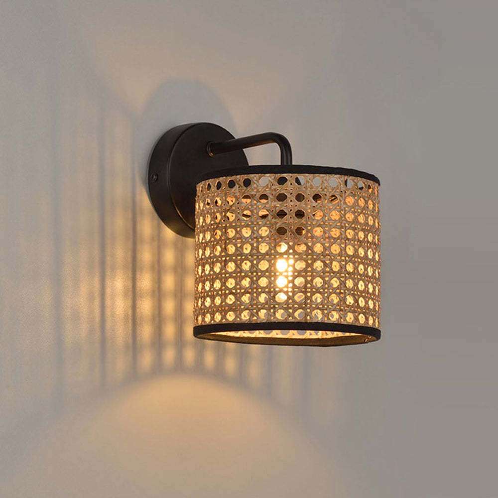 Ritta wall lamp with rattan shade, illuminating warm light