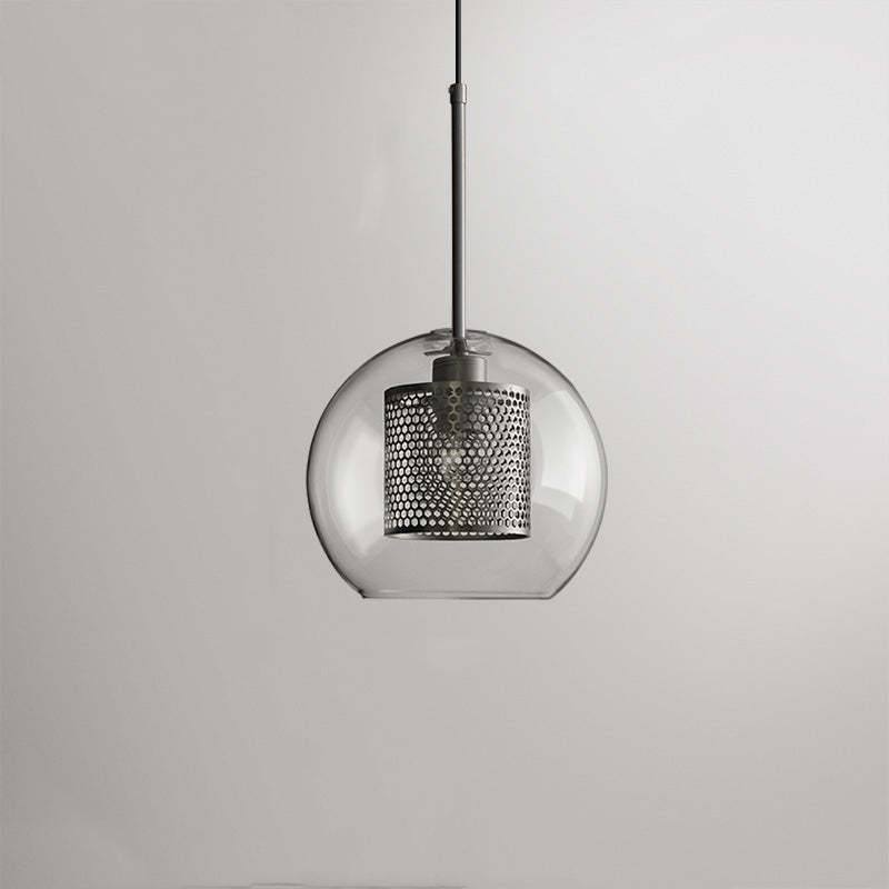 Modern pendant light with glass globe and metal accents