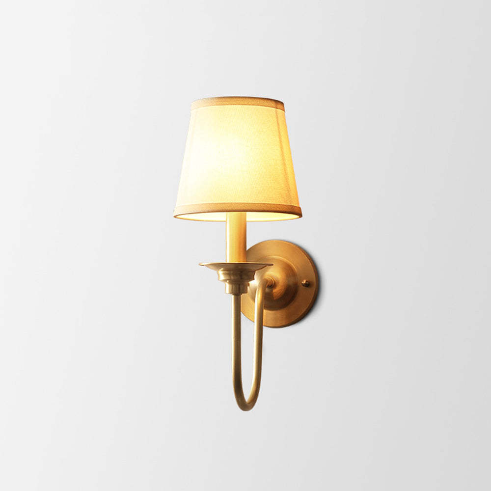 Alessio vintage gold wall lamp with fabric shade lit