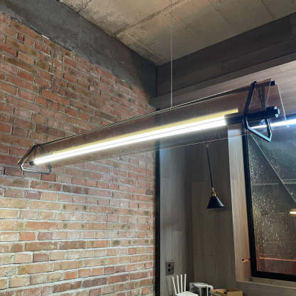 Edge Industrial Pendant Light illuminates modern brick interior