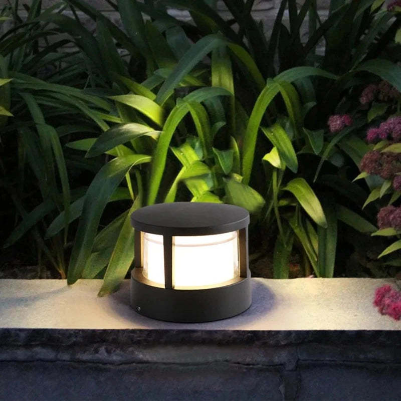 Pena outdoor bollard light illuminating a garden