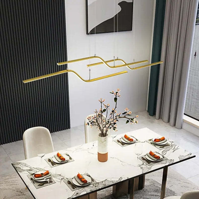 Gold minimalist pendant light over dining table