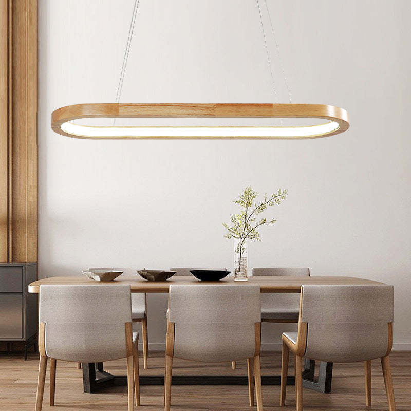 Ozawa oval wood LED pendant light above modern dining table.