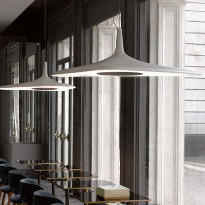 White Carins pendant lights over dining tables
