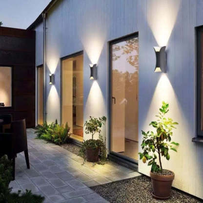 Orr LED outdoor wall light illuminating a garden corridor.