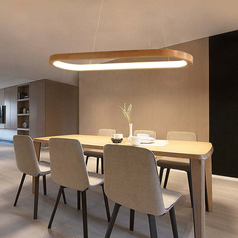 Ozawa oval wood pendant light illuminating dining area.