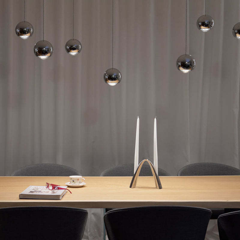 Modern metal ball pendant lights over dining table