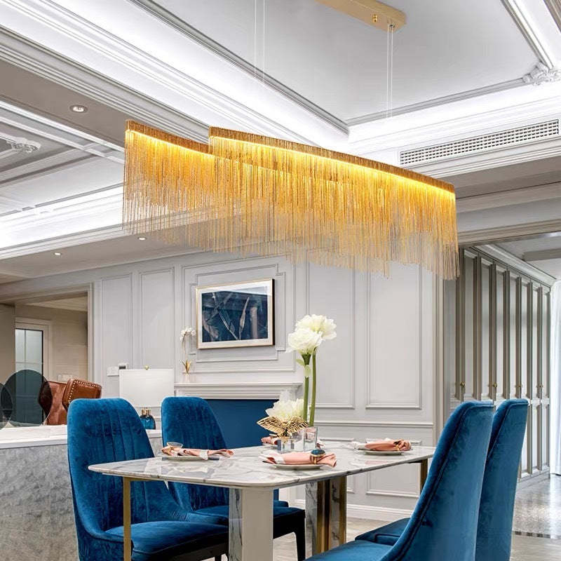 Marilyn tassel pendant light over dining table with blue chairs