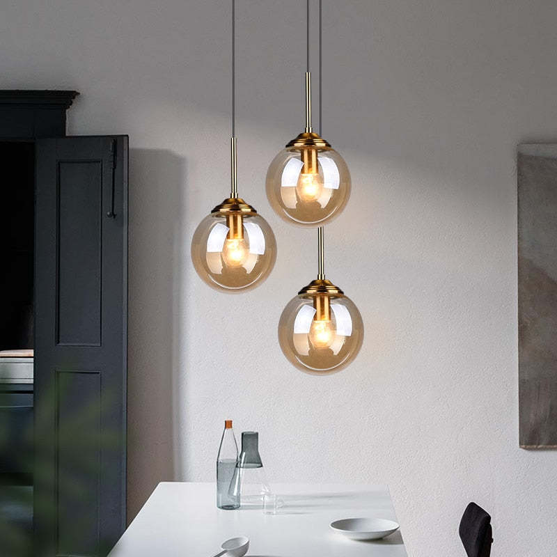 Valentina pendant light, three amber glass ball lights over dining table