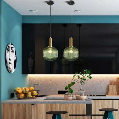 Green Hailie pendant lights over modern kitchen island.