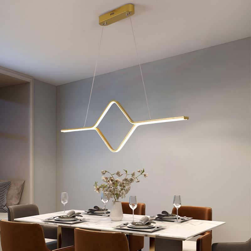 Gold linear pendant light over dining table