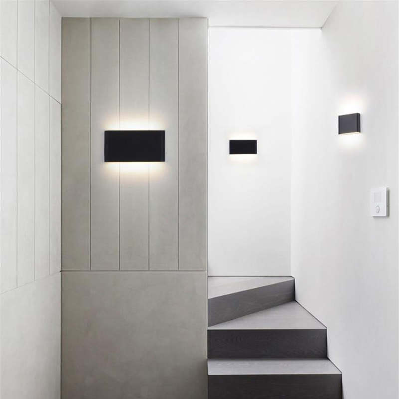 Modern black outdoor wall lamps illuminating a hallway