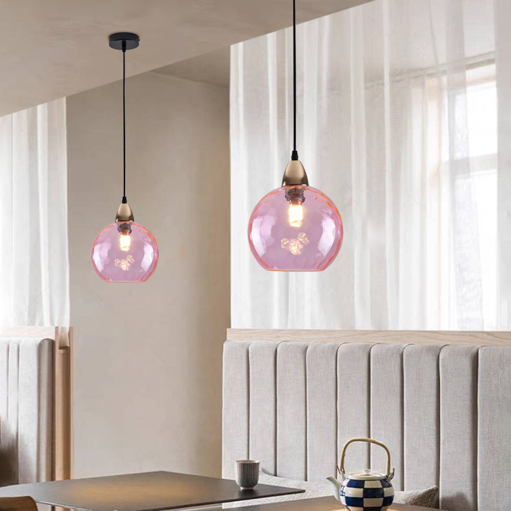Pink glass pendant lights in dining room. Hailie style lighting.