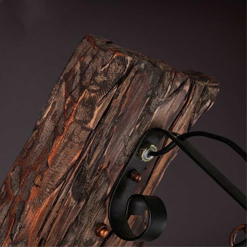 Alessio bronze wall lamp: Wood mount & metal bracket detail