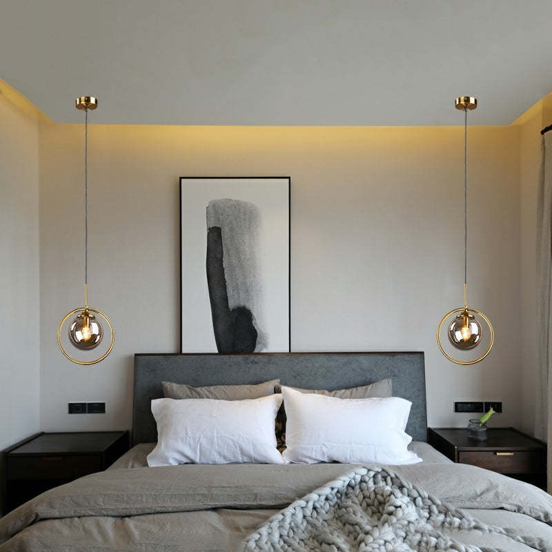 Hailie glass pendant lights in bedroom. Modern gold ring lighting.