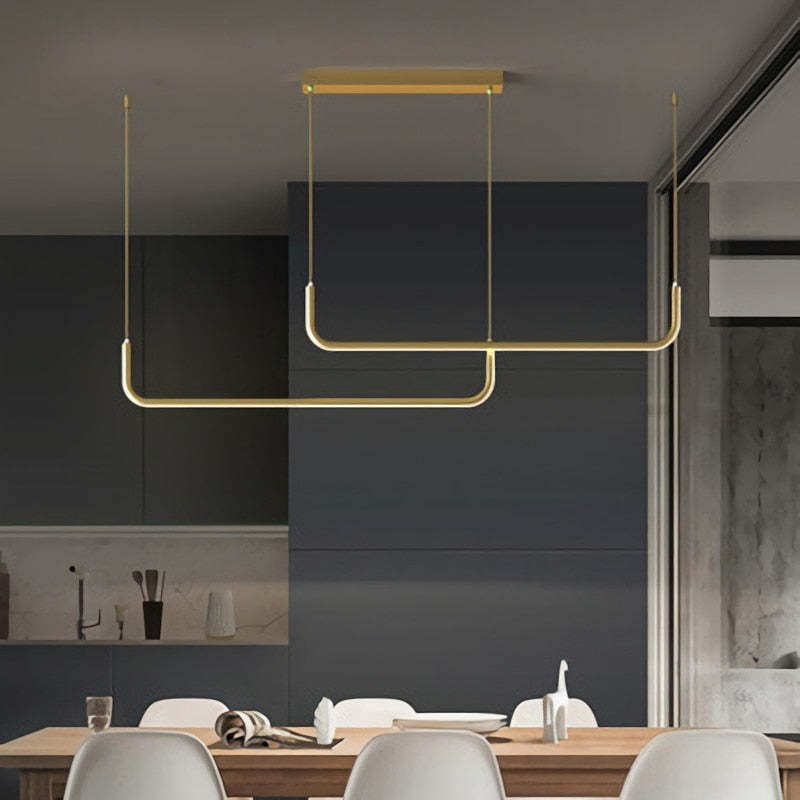Gold linear pendant light above dining table