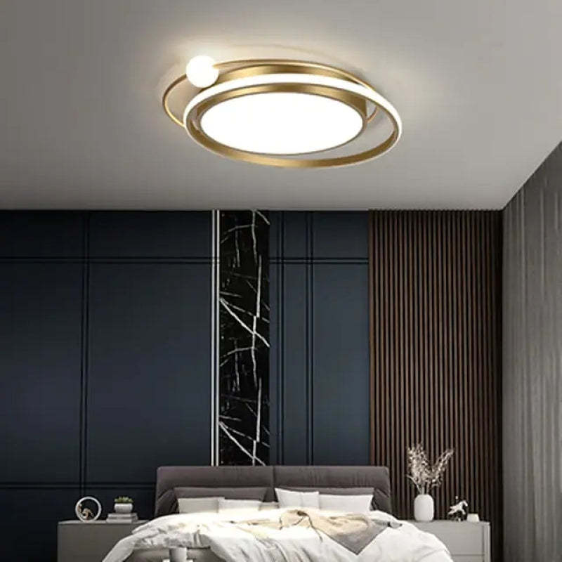 Modern gold orbit ceiling light fixture in bedroom