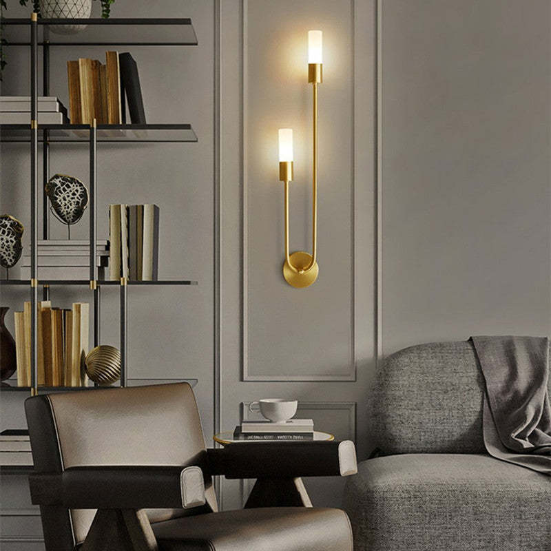 Gold Meza Wall Sconce illuminating a modern living space
