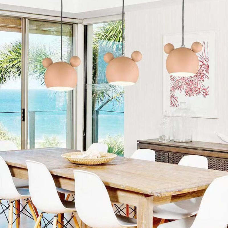 Pink cartoon pendant lights in dining room. Las Sola lighting.