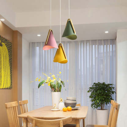 Morandi cone pendant lights above a wooden dining table.