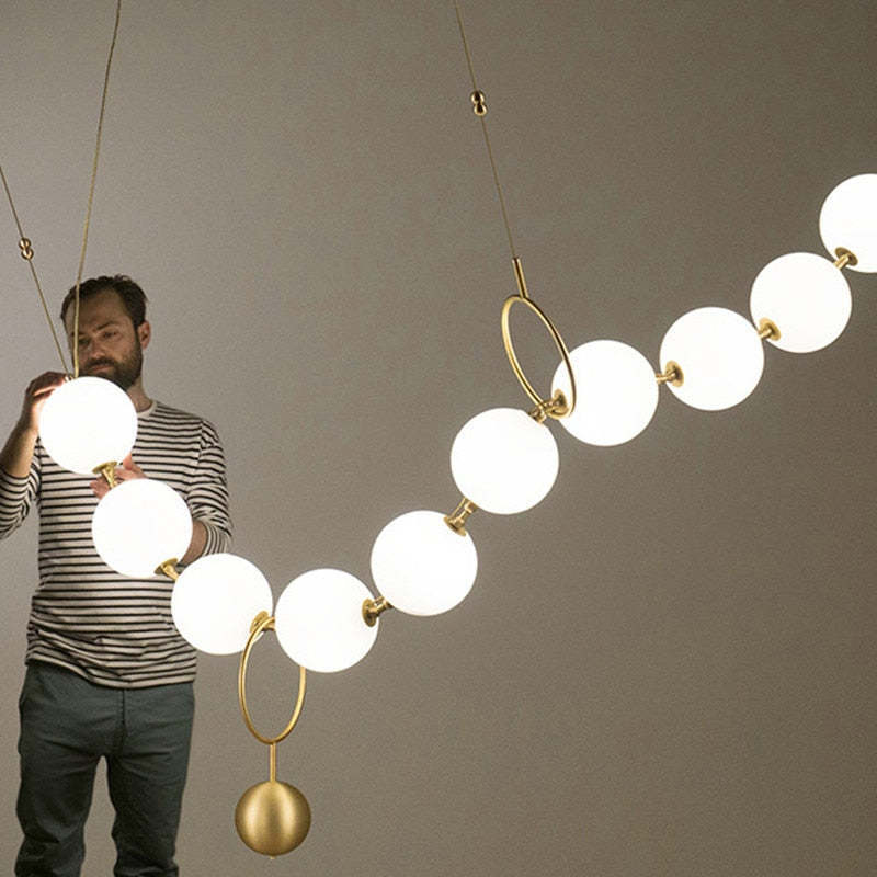 Man inspecting Valentina pendant light, creative design