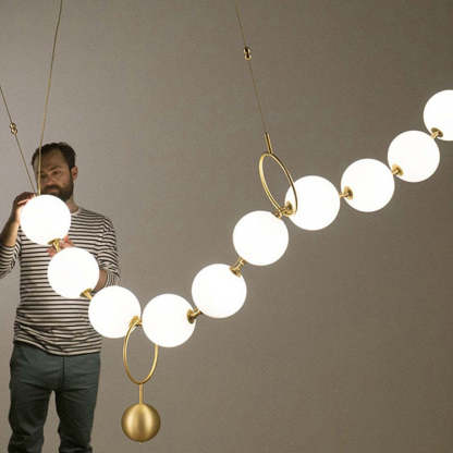 Man inspecting Valentina pendant light, creative design