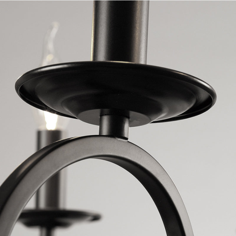 Close-up detail of a black metal chandelier with candle-shaped bulbs