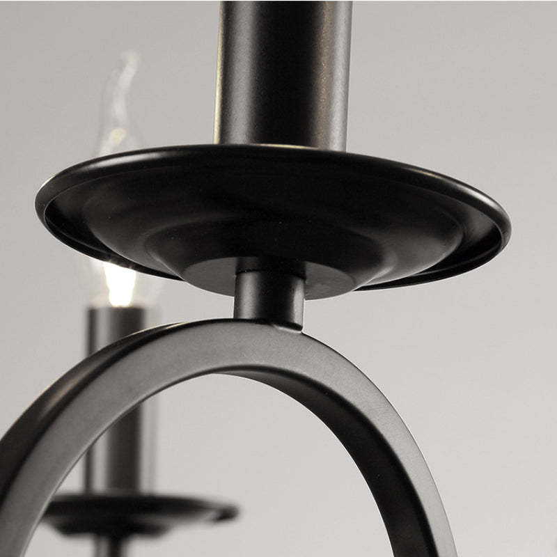 Close-up detail of a black metal chandelier with candle-shaped bulbs