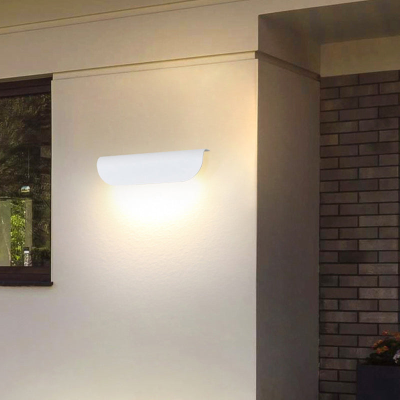 Orr Modern Curved LED Outdoor Wall Lamp illuminating a wall