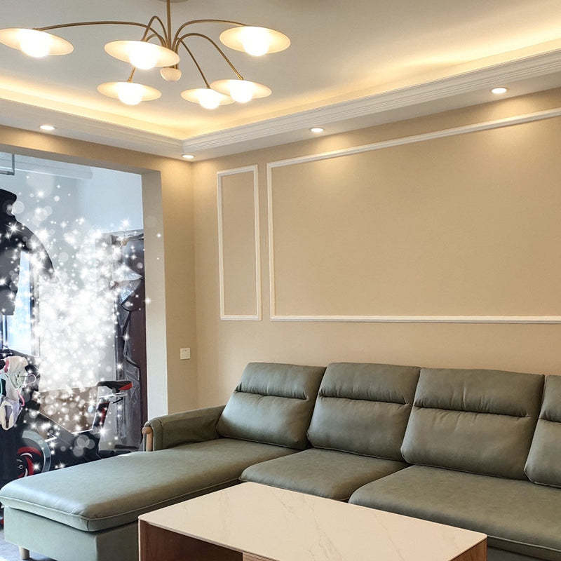 Cairns metal pendant light above a green sofa.