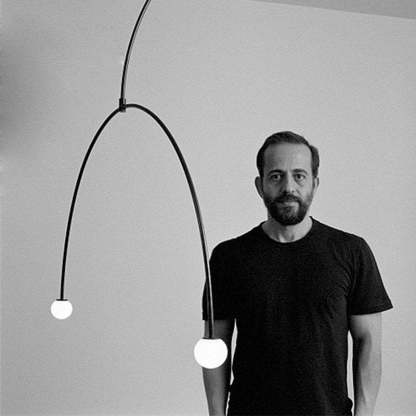 Man showcasing Avi minimalist pendant light from Las Sola