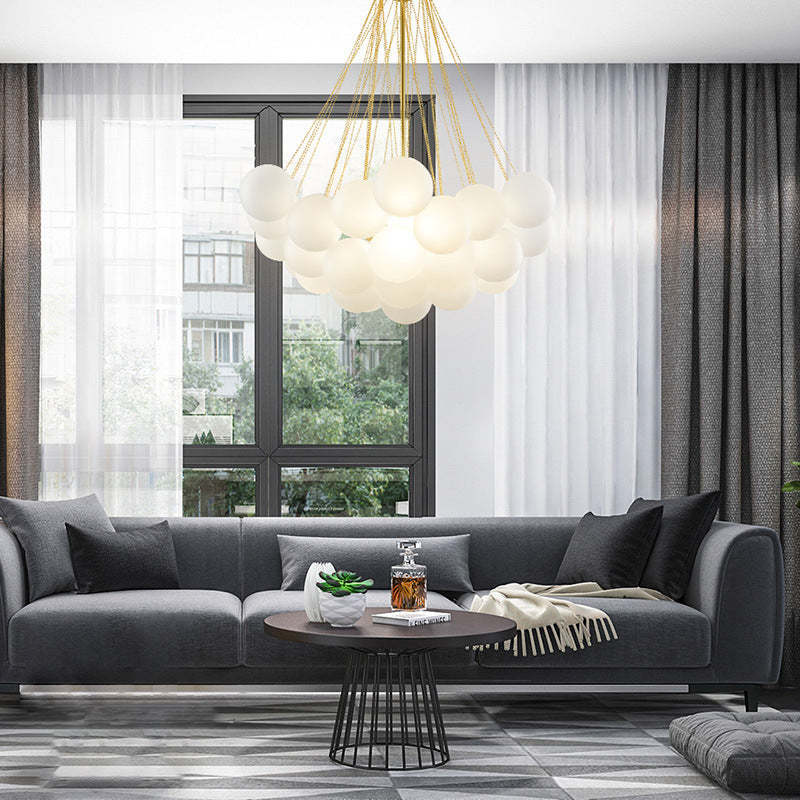 Valentina glass globe pendant light over gray sofa. Modern lighting. Valentina Glass Globe Pendant Light Bubble