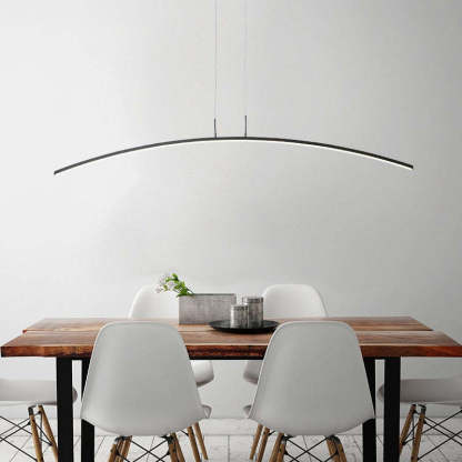 Modern curved linear pendant light above dining table.