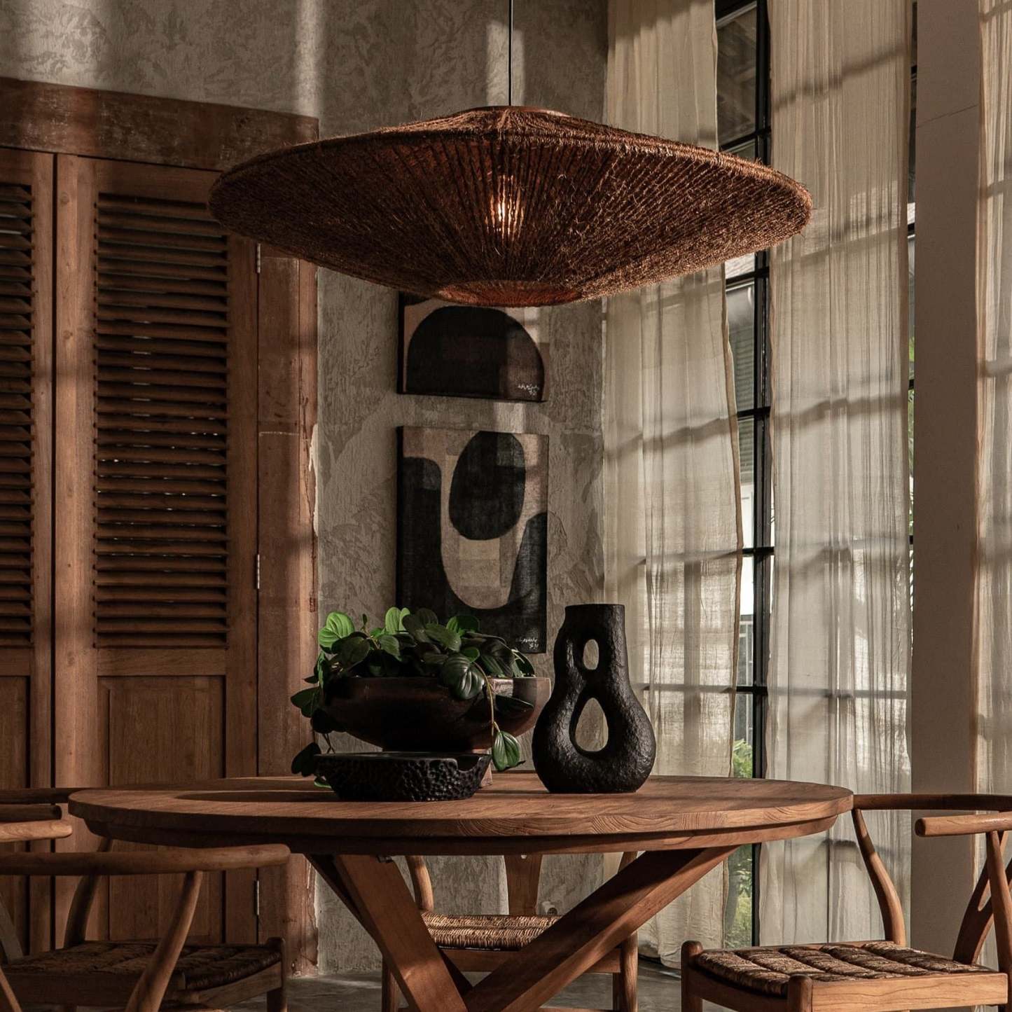 Rattan pendant light over wooden dining table, home decor