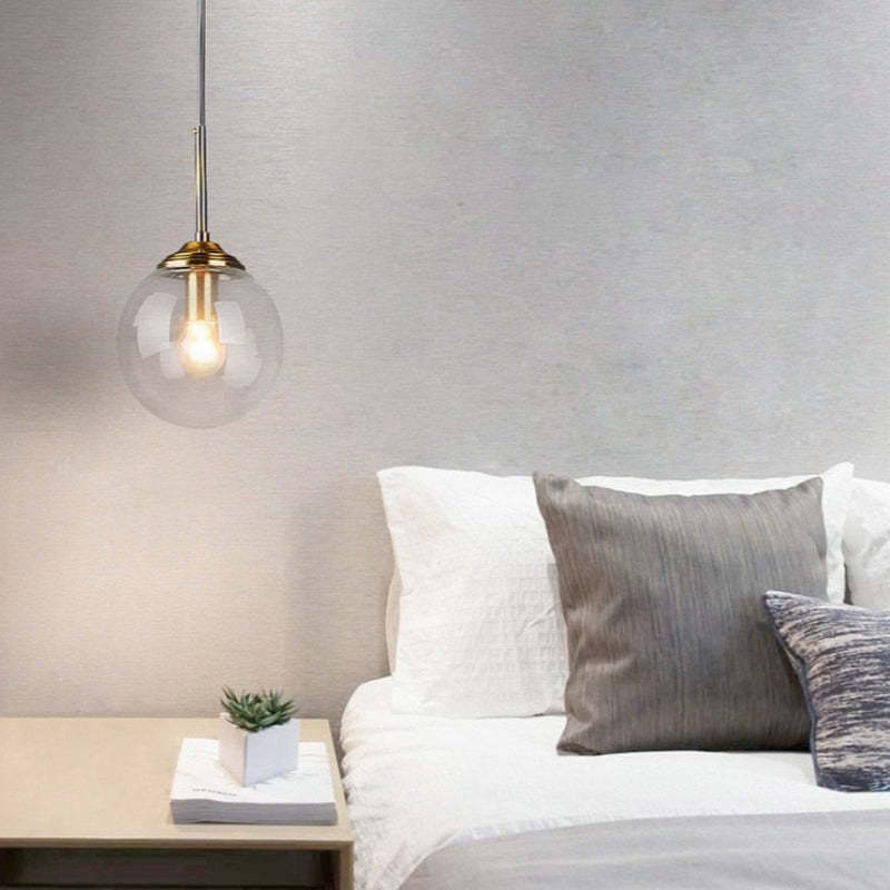 Valentina glass pendant light over a bed in a bedroom