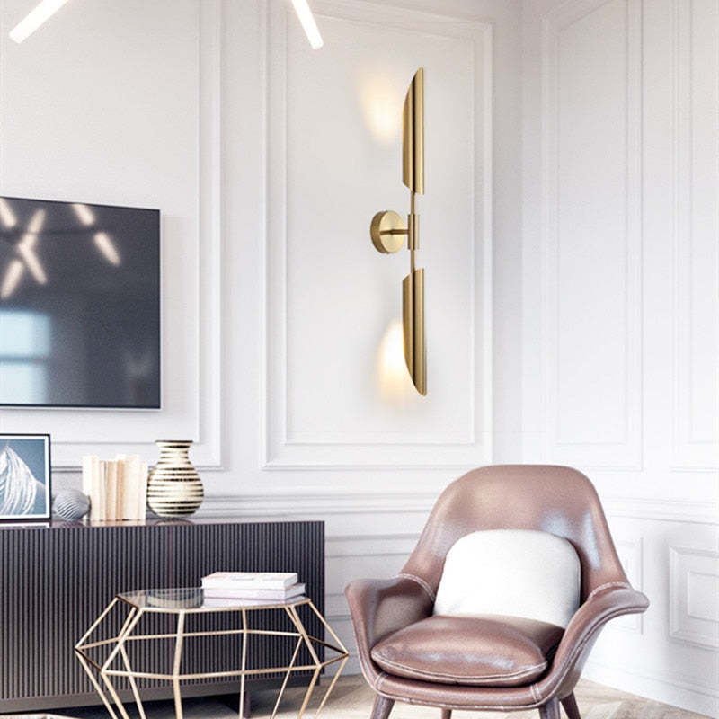 Meza Gold Wall Lamp illuminating a modern living space