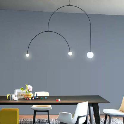 Minimalist metal pendant lighting above dining table. Las Sola