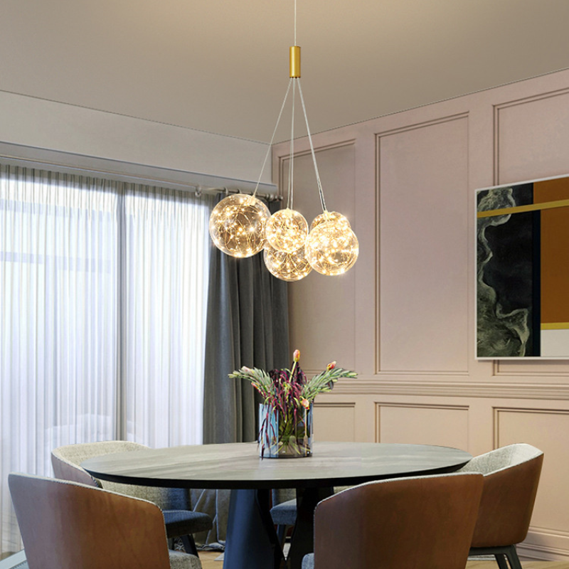 Valentina pendant light over dining table, with a vase of flowers