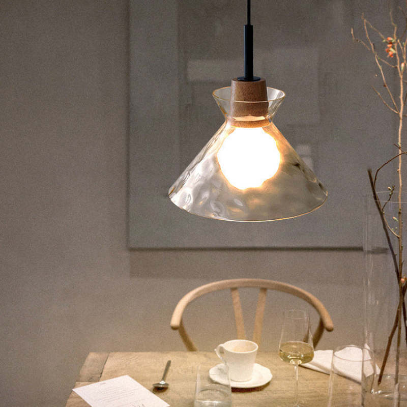 Cone Levy glass pendant light over a dining table.